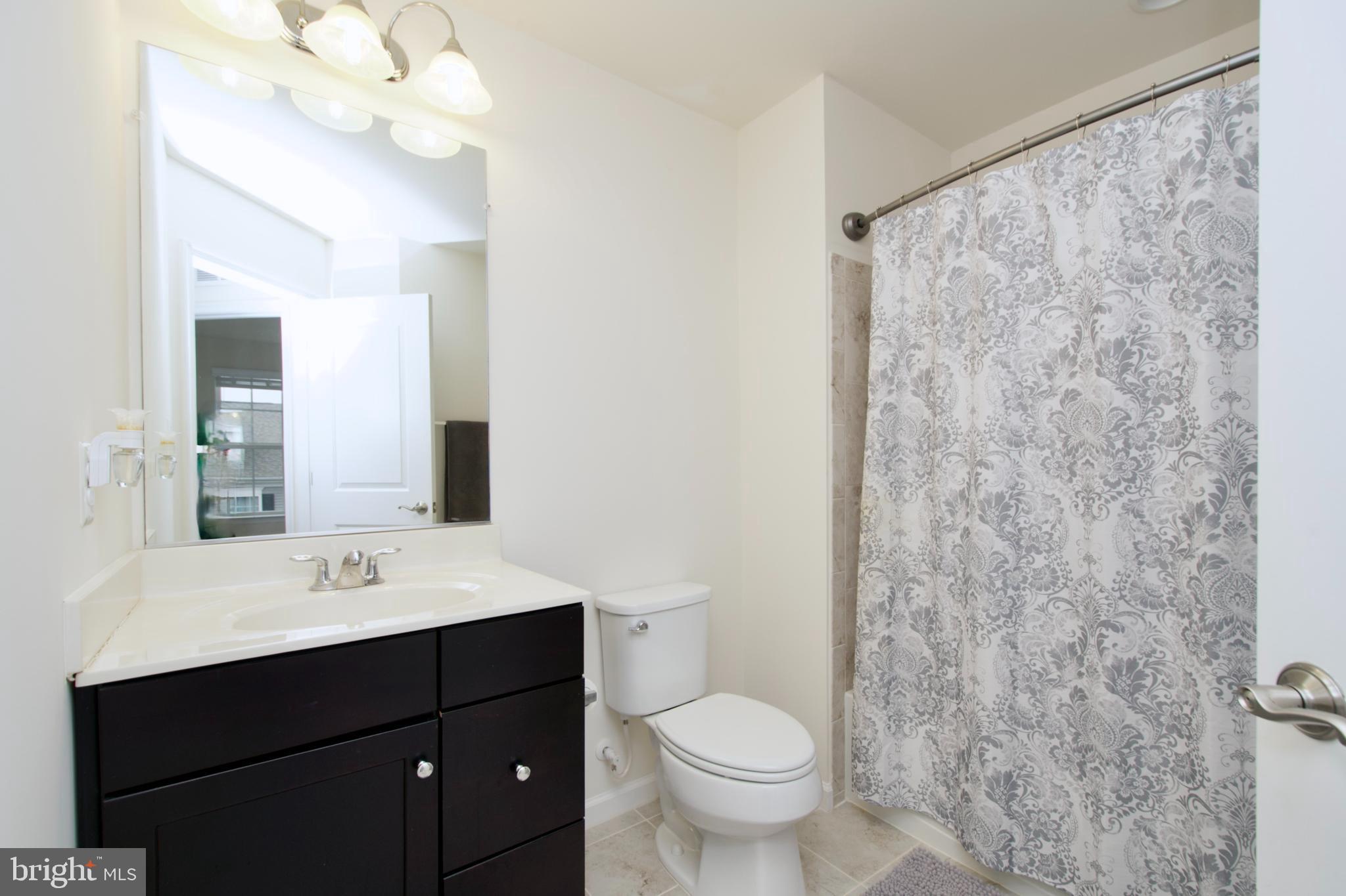 2900 Pinebrook Road Landover, MD 20785 - Photo 39 of 46 a bathroom with a sink vanity mirror and toilet