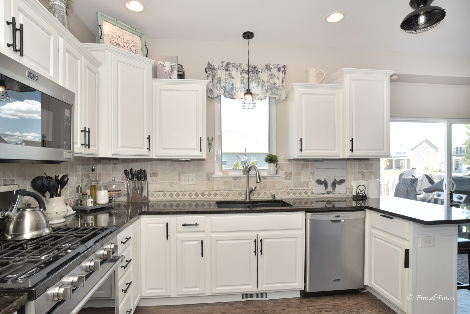 7446 Alexandra Lane Union, IL 60180 - Photo 5 of 22 a kitchen with granite countertop a sink stainless steel appliances and cabinets