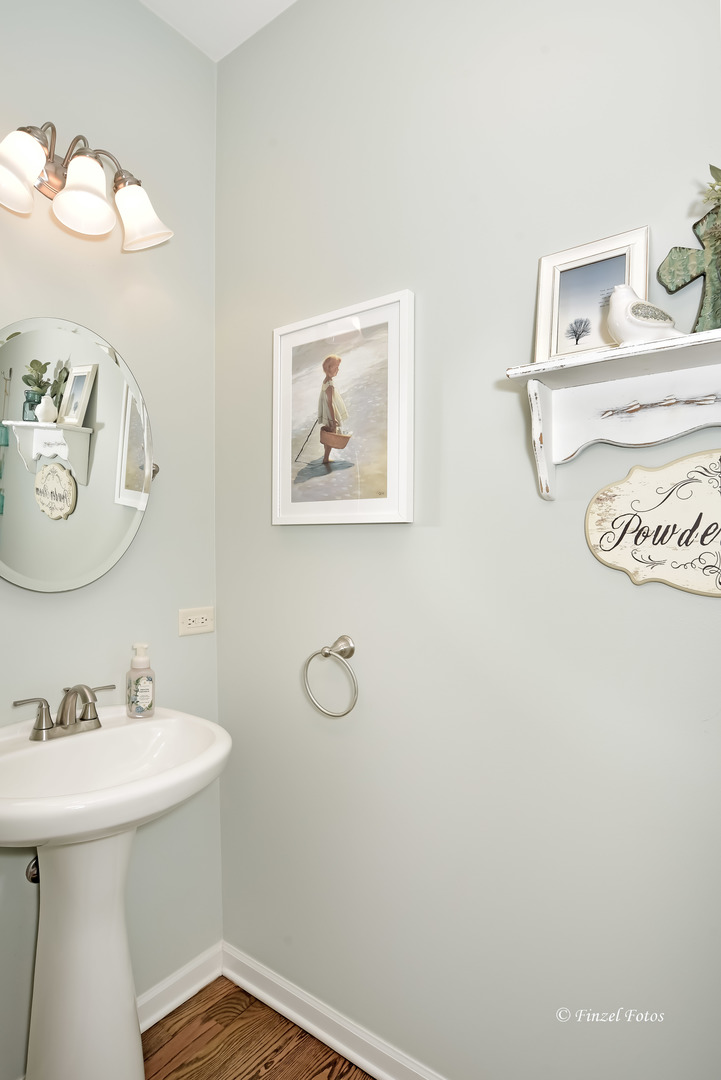 7446 Alexandra Lane Union, IL 60180 - Photo 8 of 22 a bathroom with a sink a mirror and vanity