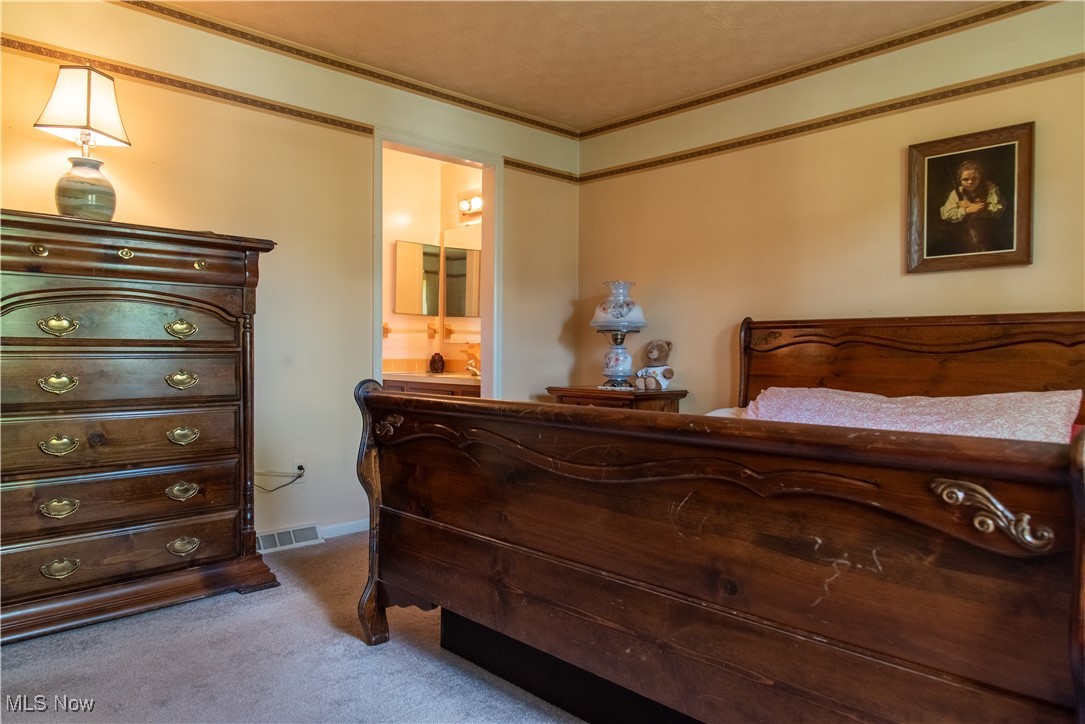 7969 Bricker Road Northwest Clinton, OH 44216 - Photo 12 of 23 Primary bedroom with carpet floors