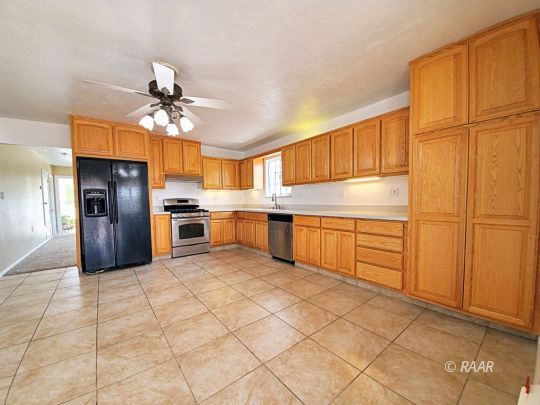 1037 South Ranger Street Ridgecrest, CA 93555 - Photo 2 of 26 a kitchen with stainless steel appliances granite countertop a refrigerator and a sink