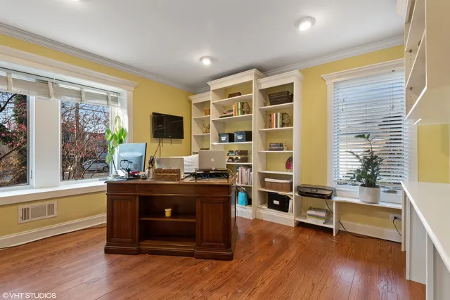 a living room with furniture flat screen tv and wooden floor