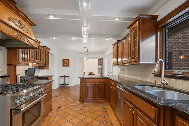 a kitchen with stainless steel appliances granite countertop a sink stove and cabinets