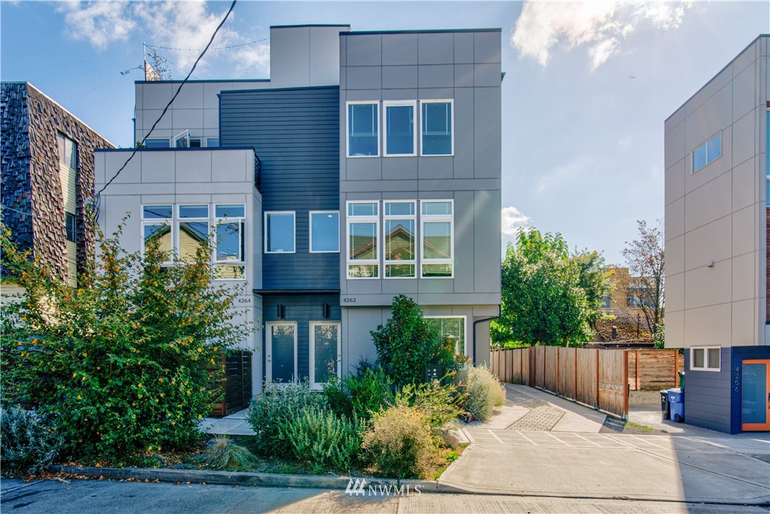 4262 Linden Avenue North Seattle, WA 98103 - Photo 2 of 40 a view of a brick house many windows and plants