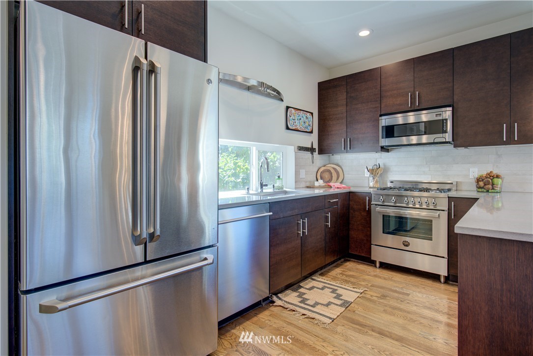 4262 Linden Avenue North Seattle, WA 98103 - Photo 11 of 40 a kitchen with stainless steel appliances a stove a sink and a refrigerator