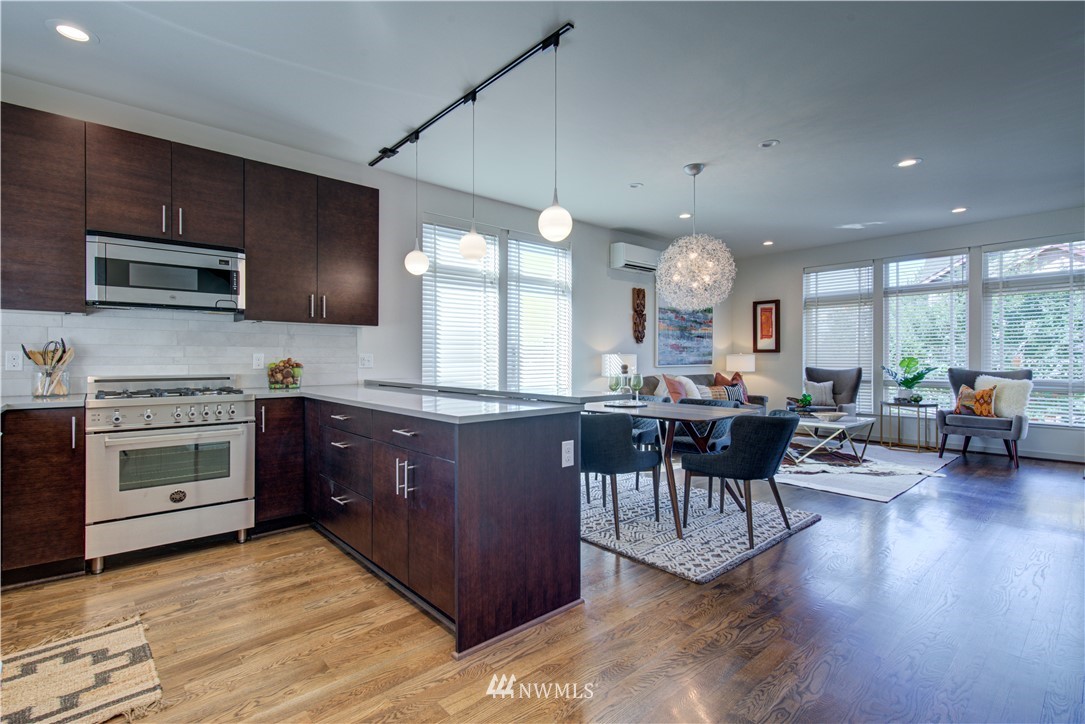4262 Linden Avenue North Seattle, WA 98103 - Photo 13 of 40 a kitchen with stainless steel appliances granite countertop wooden cabinets a stove and a sink