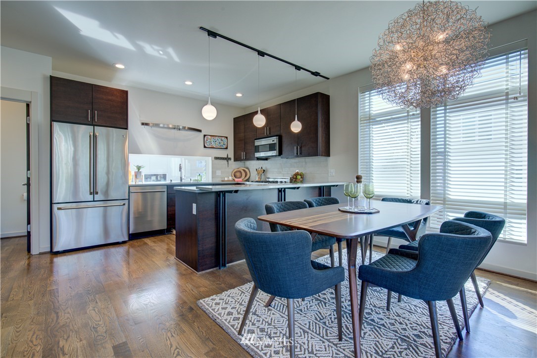 4262 Linden Avenue North Seattle, WA 98103 - Photo 18 of 40 a view of a dining room with furniture window and wooden floor