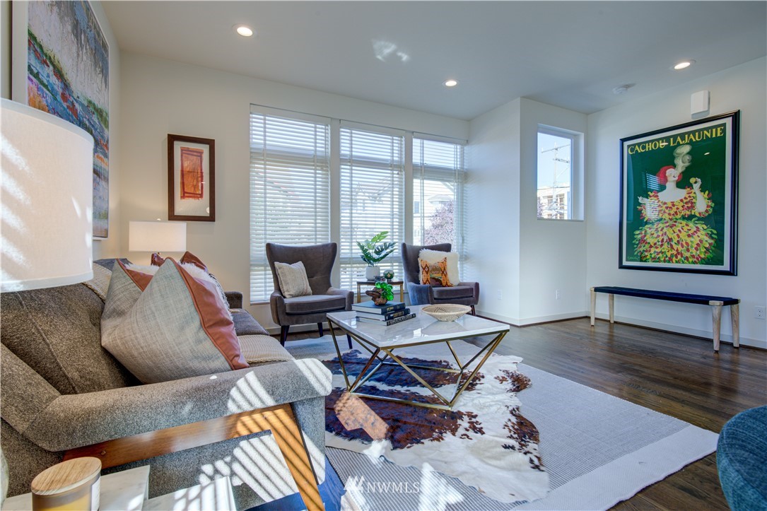 4262 Linden Avenue North Seattle, WA 98103 - Photo 23 of 40 a living room with furniture two large window and wooden floor