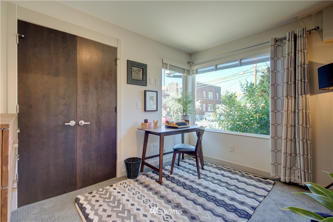 4262 Linden Avenue North Seattle, WA 98103 - Photo 8 of 40 a workspace with wooden floor and a window