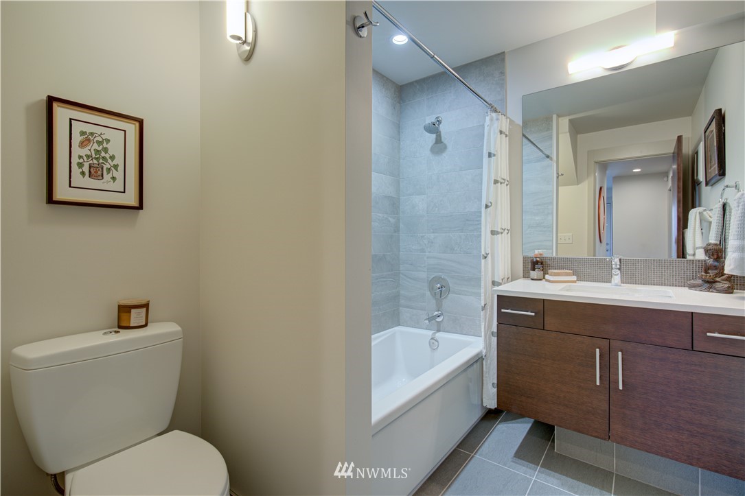 4262 Linden Avenue North Seattle, WA 98103 - Photo 9 of 40 a bathroom with a toilet sink and mirror