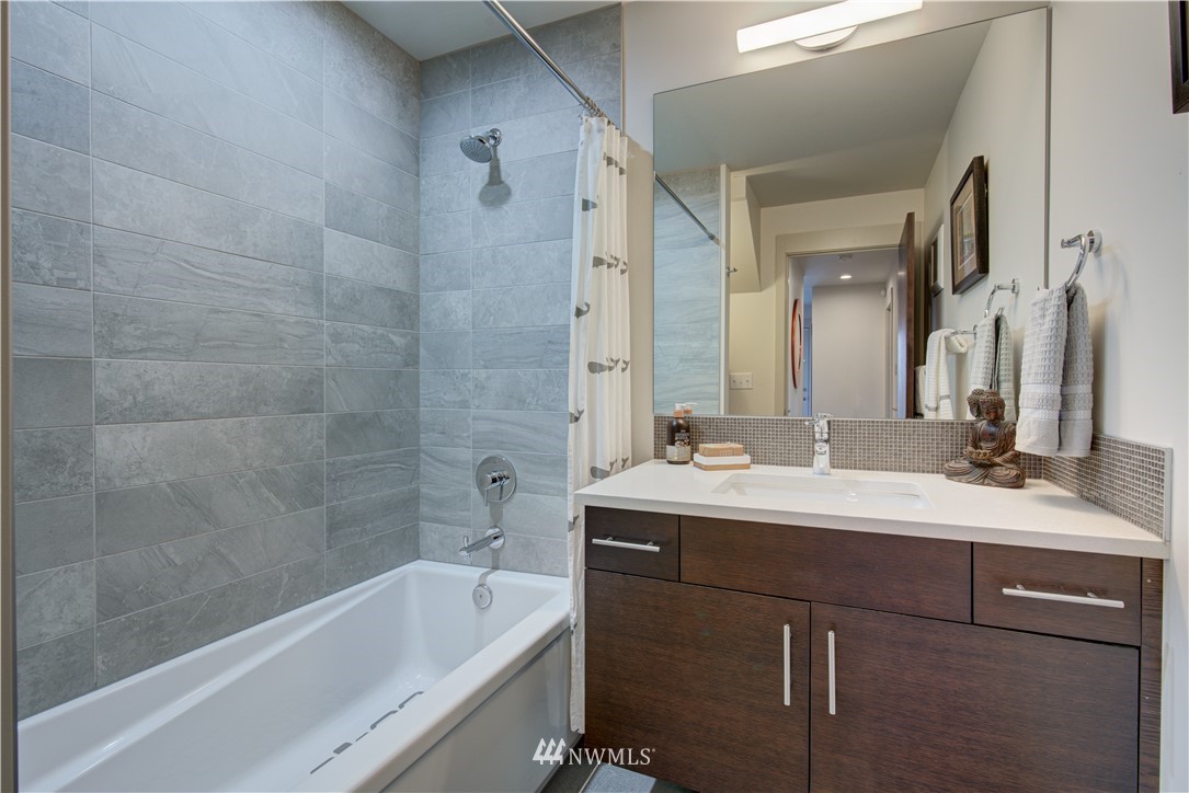 4262 Linden Avenue North Seattle, WA 98103 - Photo 10 of 40 a bathroom with a tub sink and mirror