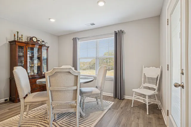 a view of a livingroom with furniture window and wooden floor