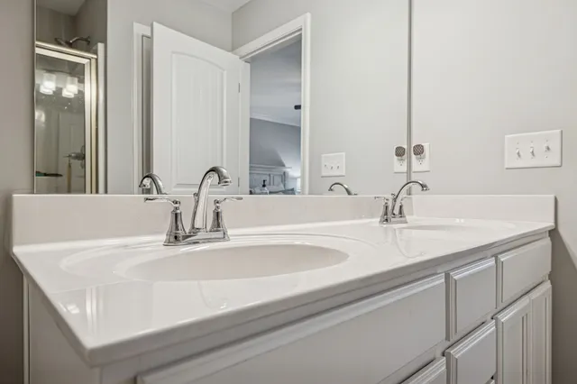 a bathroom with a sink a toilet a shower and a mirror