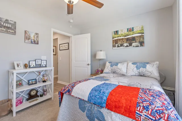 a bedroom with a bed and a chandelier