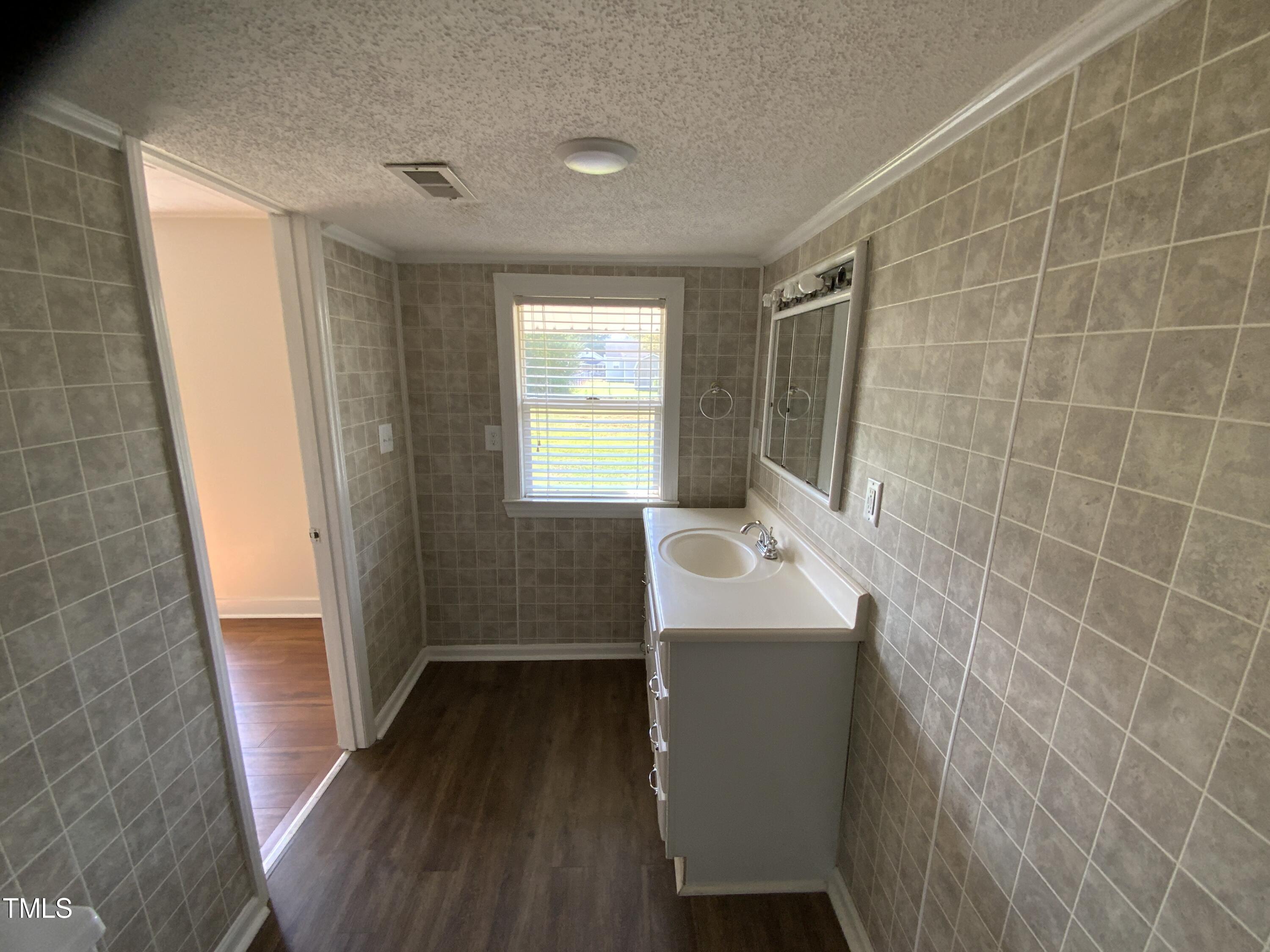 235 East Jackson Street Coats, NC 27521 - Photo 11 of 17 a bathroom with a sink and a mirror