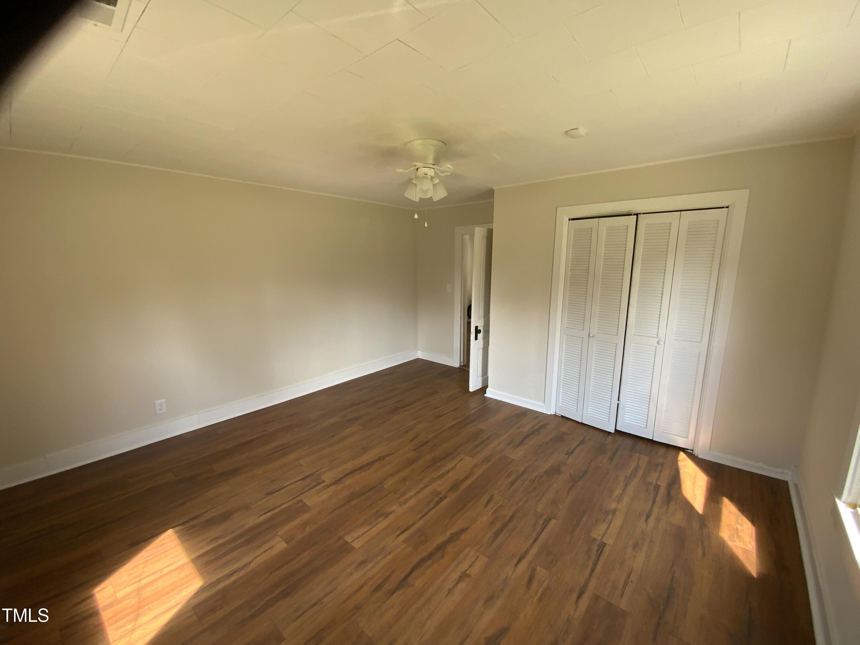 235 East Jackson Street Coats, NC 27521 - Photo 13 of 17 a view of empty room with wooden floor and fan