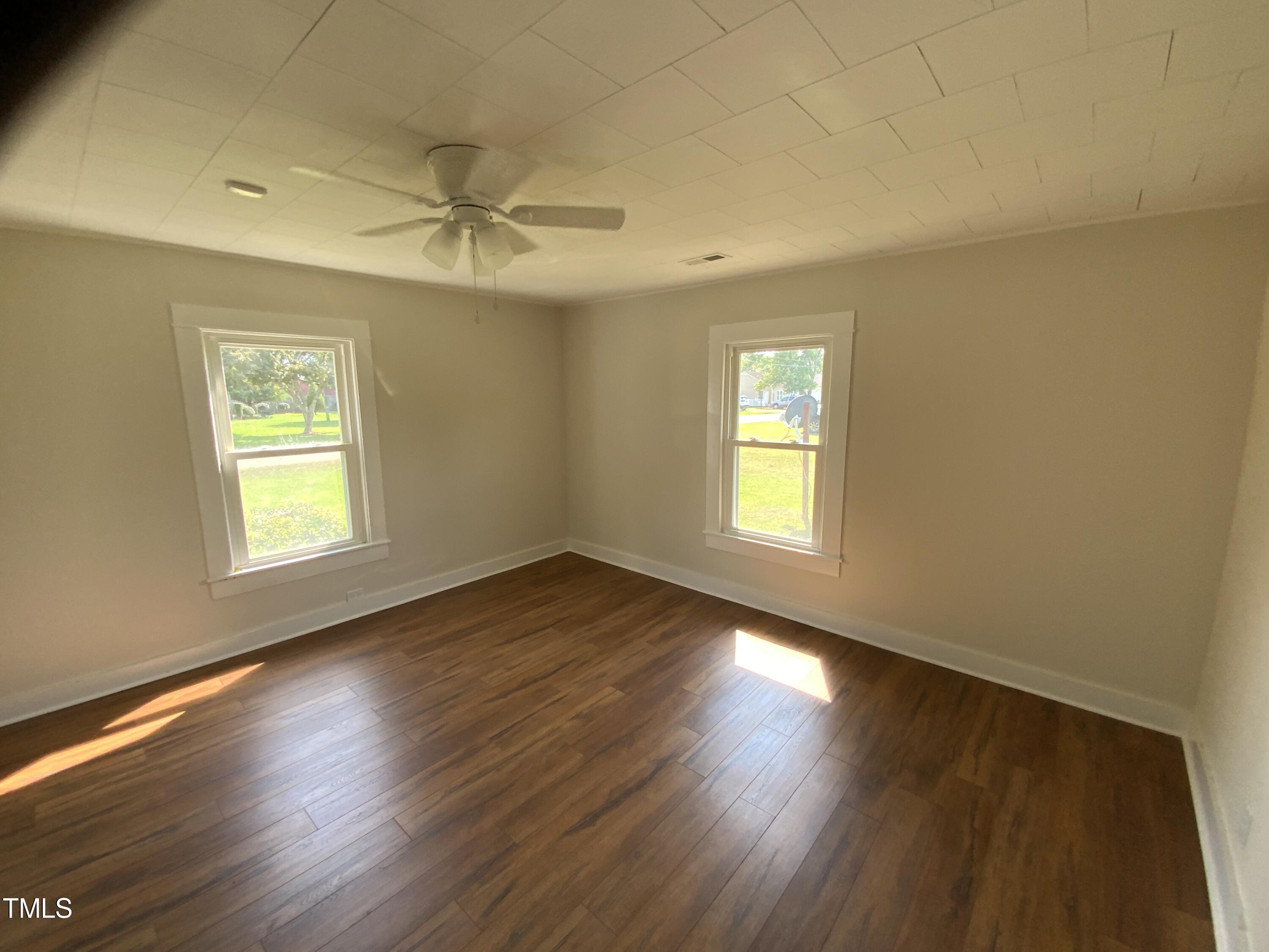 235 East Jackson Street Coats, NC 27521 - Photo 14 of 17 a view of an empty room with wooden floor and a window