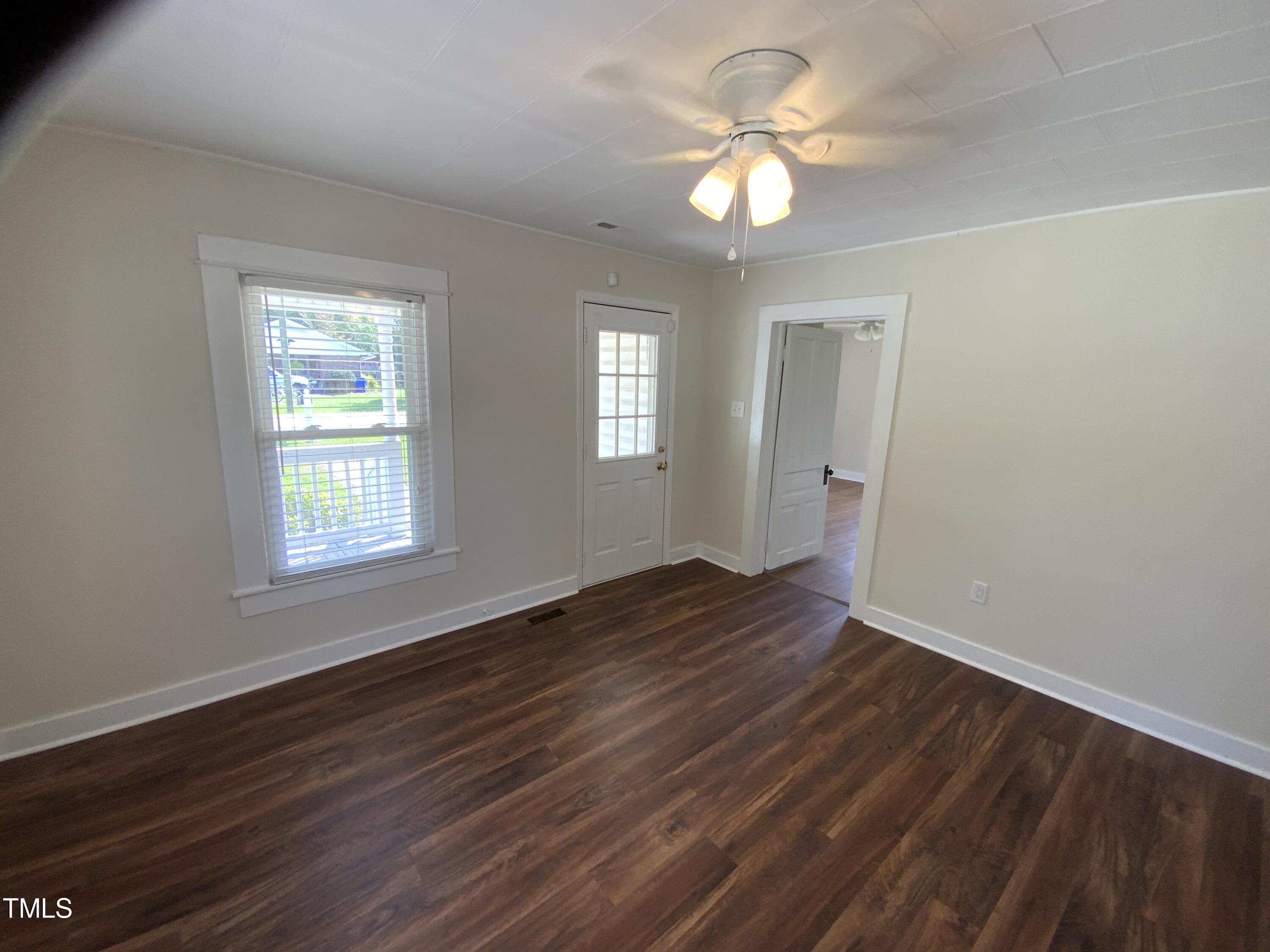 235 East Jackson Street Coats, NC 27521 - Photo 15 of 17 a view of an empty room with window and wooden floor
