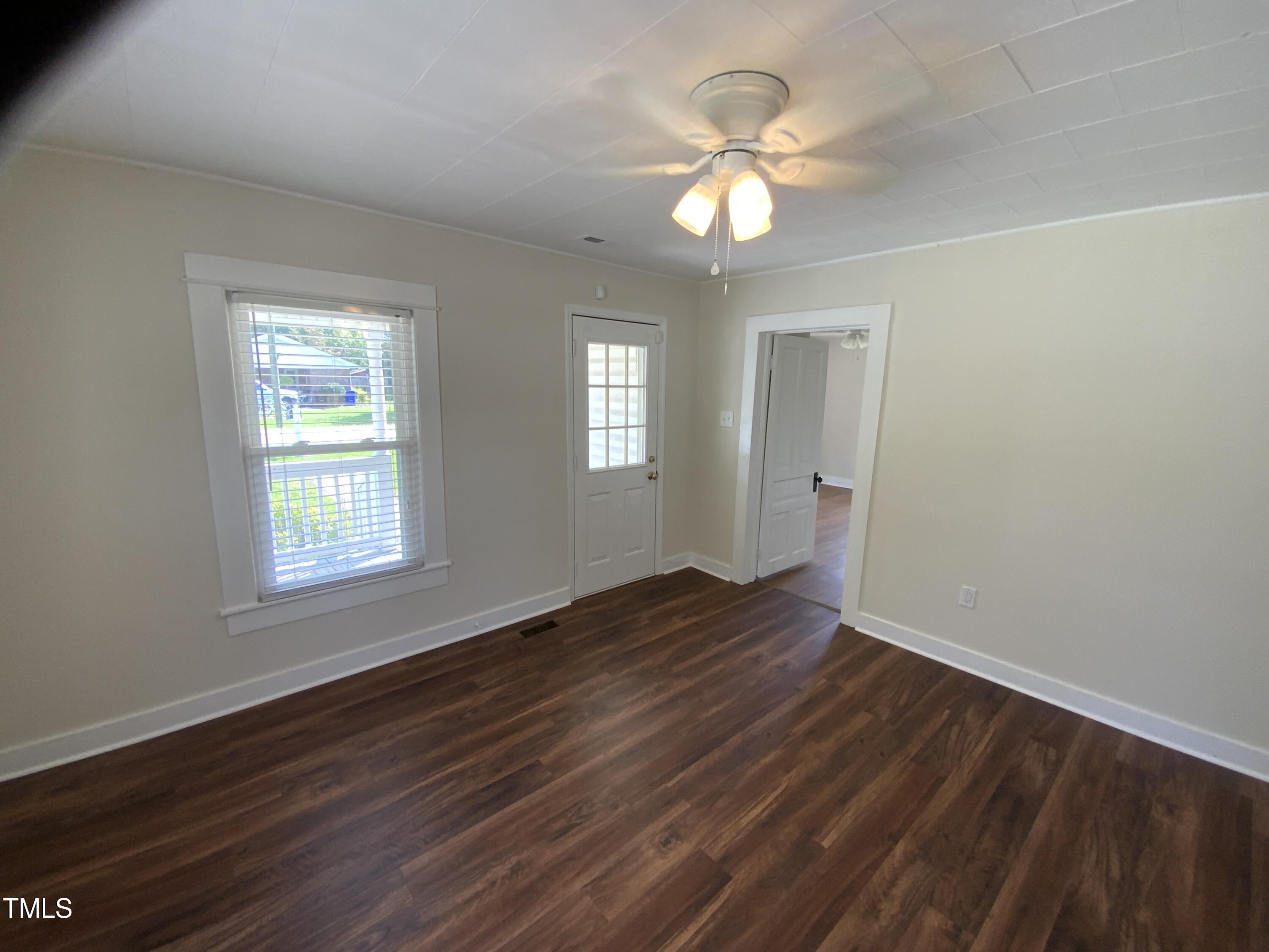 235 East Jackson Street Coats, NC 27521 - Photo 16 of 17 a view of an empty room with wooden floor and a window