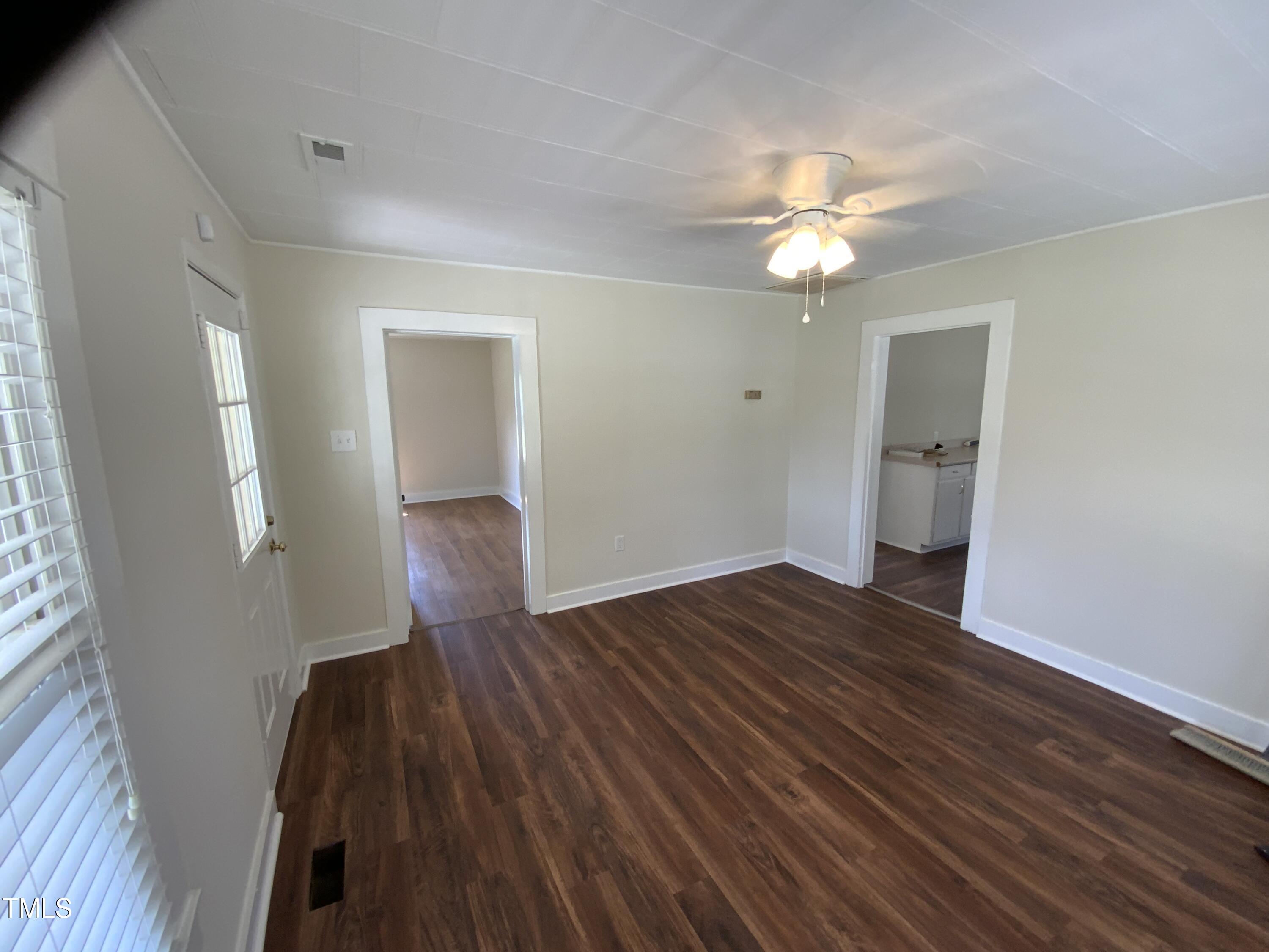 235 East Jackson Street Coats, NC 27521 - Photo 4 of 17 wooden floor in an empty room with a window