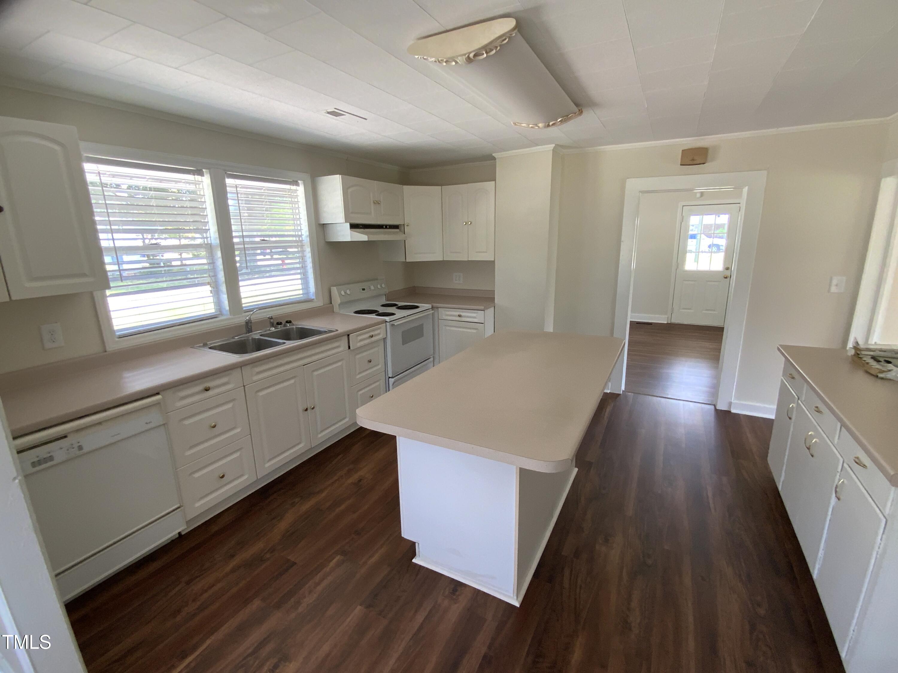 235 East Jackson Street Coats, NC 27521 - Photo 9 of 17 a kitchen with a stove a sink and wooden floor