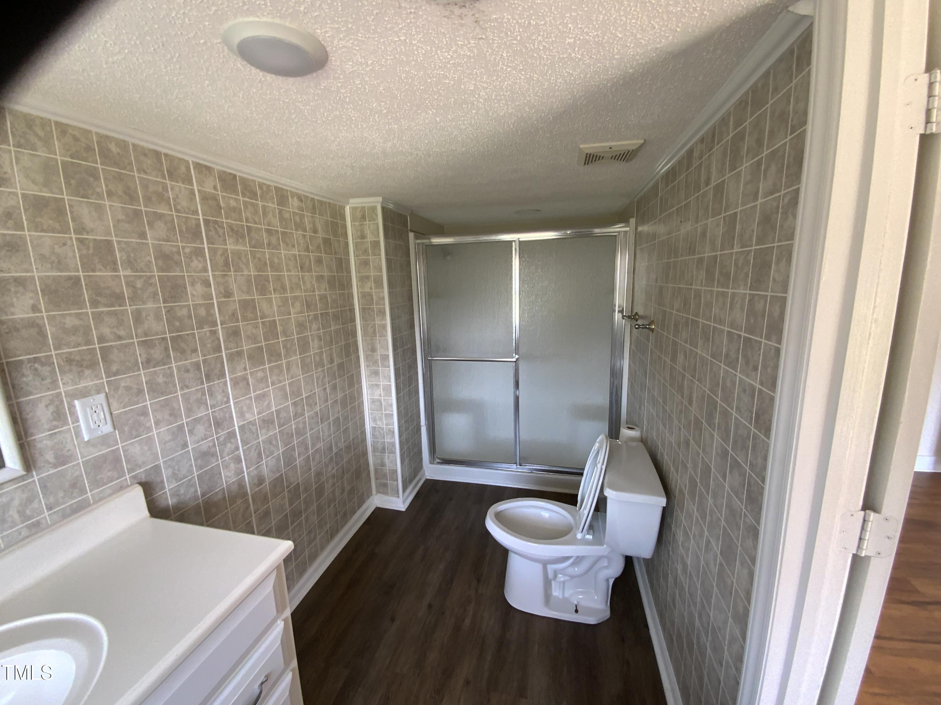 235 East Jackson Street Coats, NC 27521 - Photo 10 of 17 a bathroom with a sink and a mirror