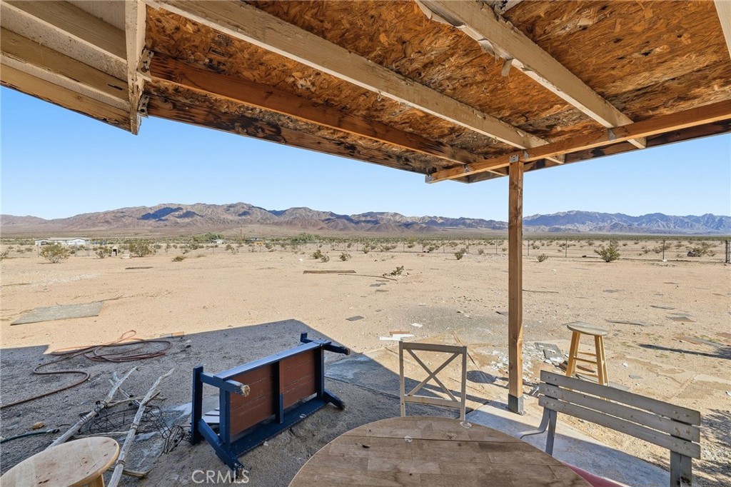 83626 Carey Road Twentynine Palms, CA 92277 - Photo 14 of 30 a view of a lake with a table and chairs in wooden floor
