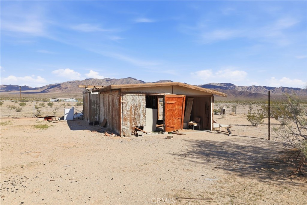 83626 Carey Road Twentynine Palms, CA 92277 - Photo 7 of 30 a view of a house with a snow in the yard