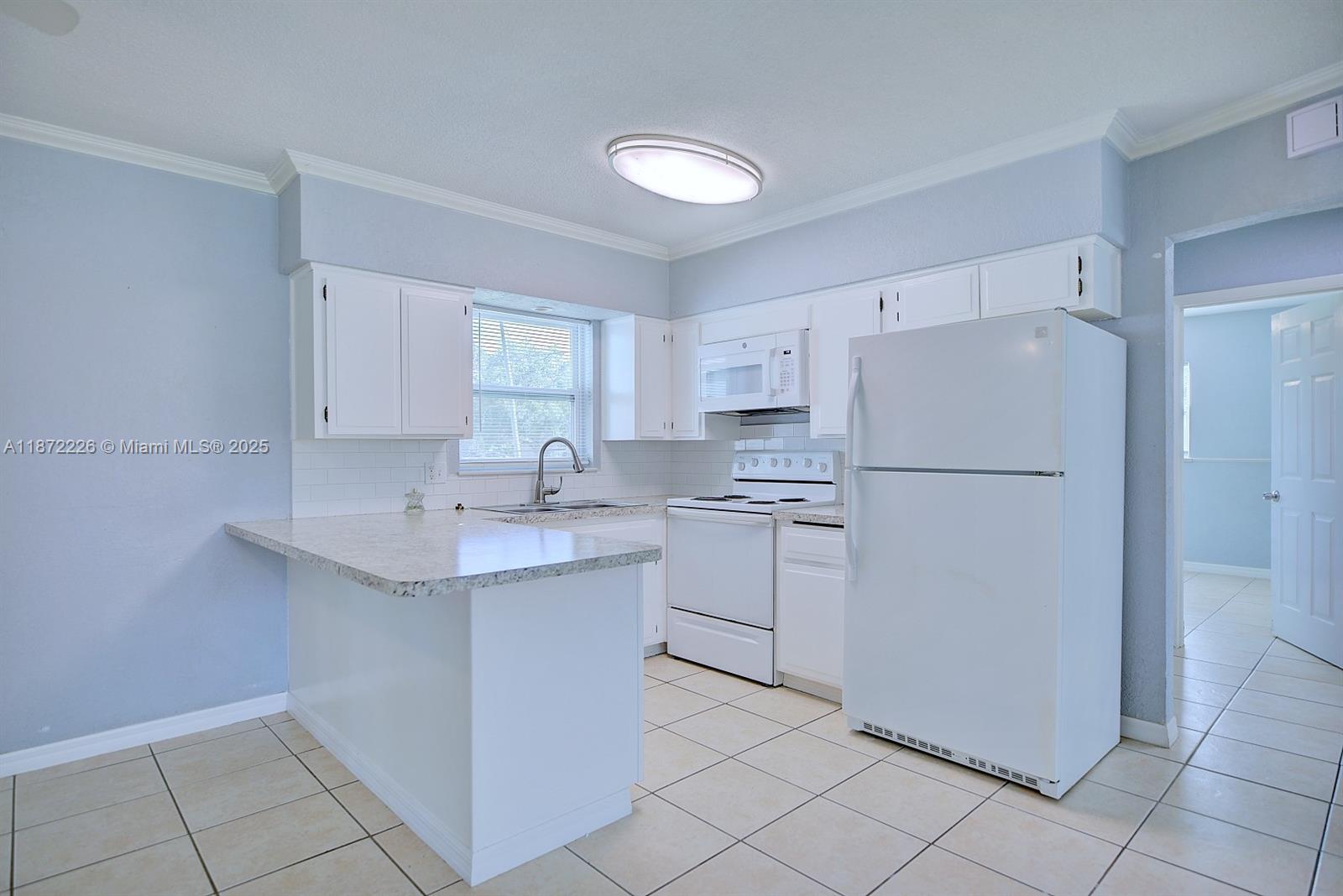 3308 Austin Street Sebring, FL 33872 - Photo 15 of 33 a kitchen with appliances a sink and cabinets