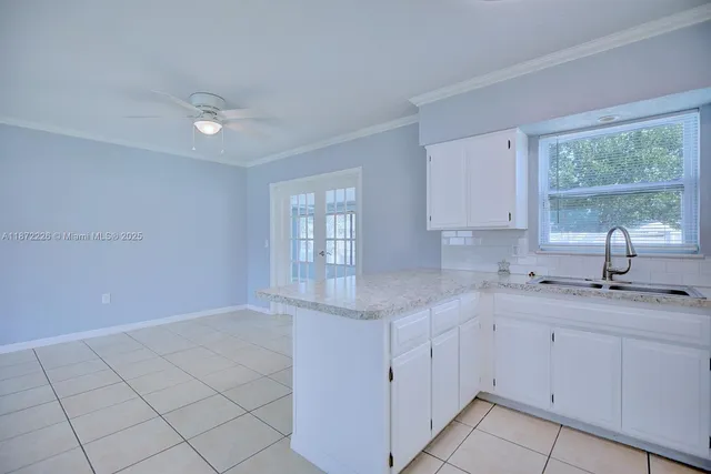 a kitchen with a sink cabinets and window