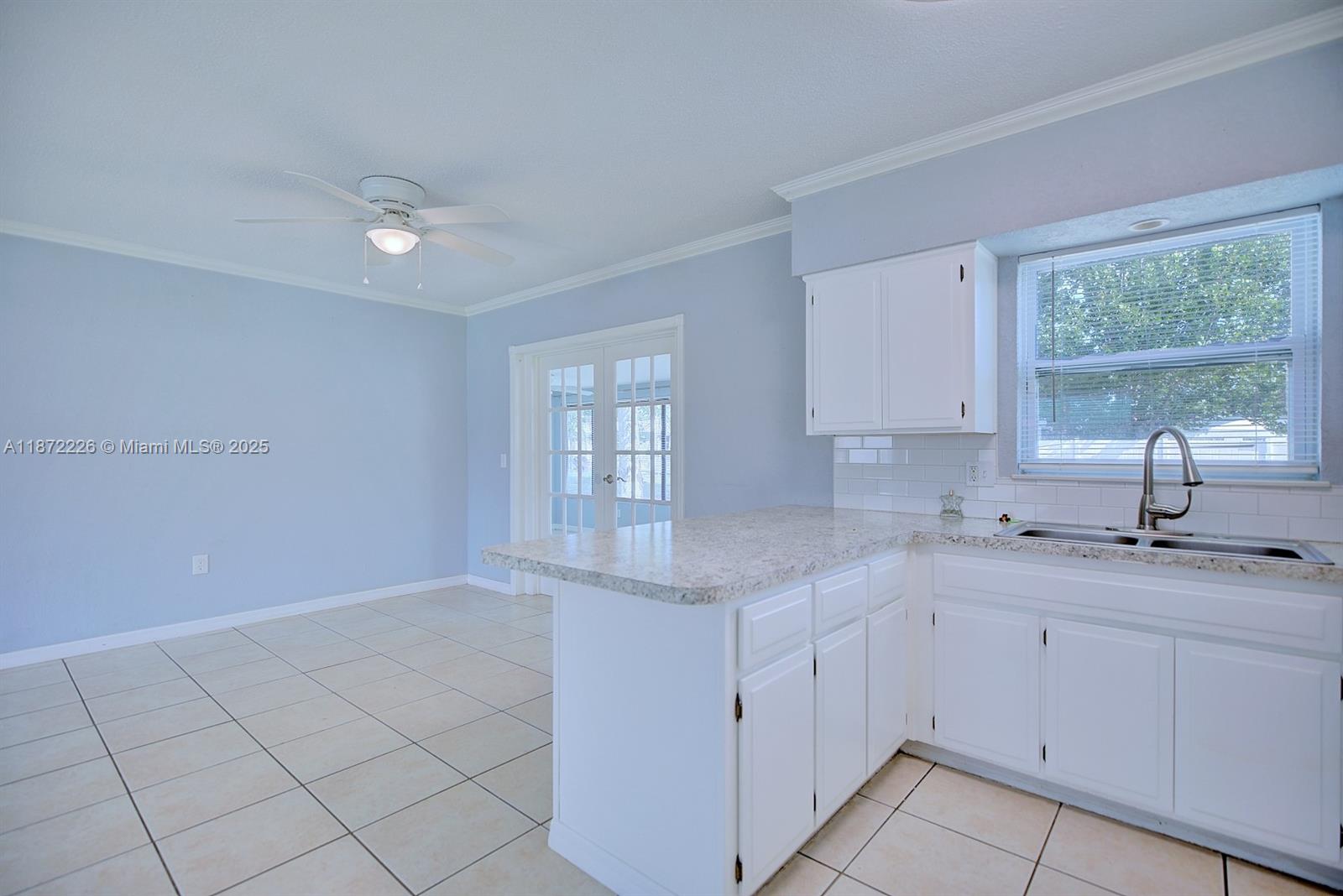 3308 Austin Street Sebring, FL 33872 - Photo 16 of 33 a kitchen with a sink cabinets and window
