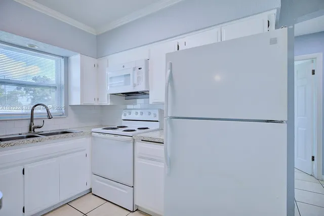 a white refrigerator freezer sitting inside of a kitchen