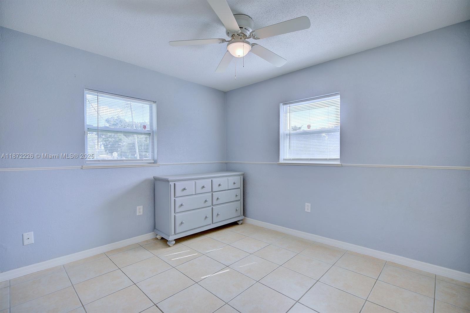 3308 Austin Street Sebring, FL 33872 - Photo 21 of 33 an empty room with windows and fan