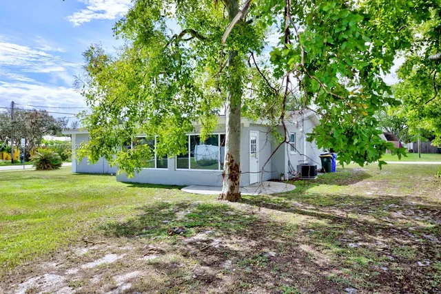 a view of a tree in front of a house
