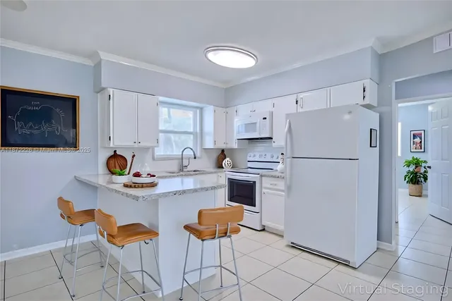 a kitchen with stainless steel appliances a refrigerator and a stove top oven