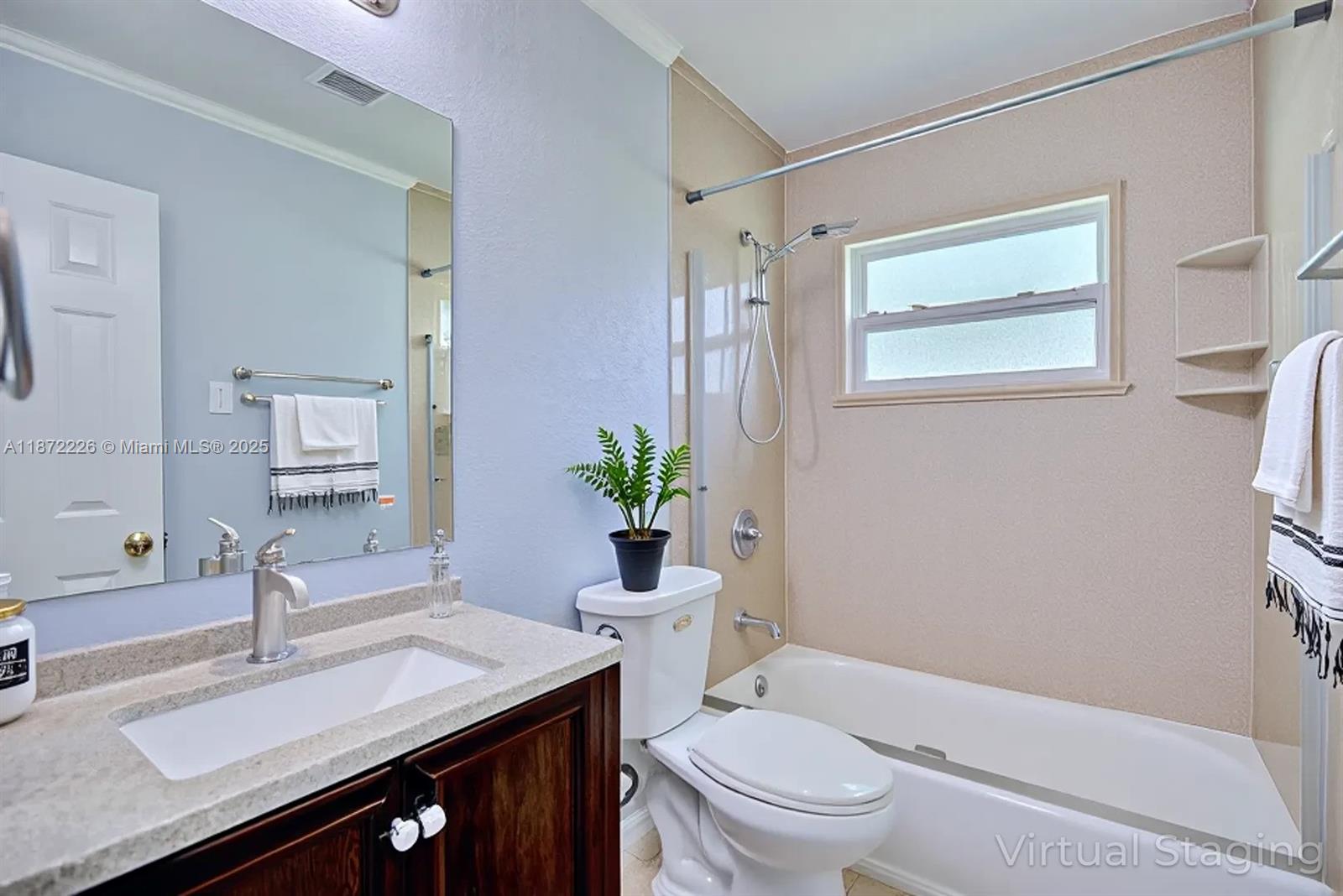 3308 Austin Street Sebring, FL 33872 - Photo 8 of 33 a bathroom with a sink a toilet a mirror and shower