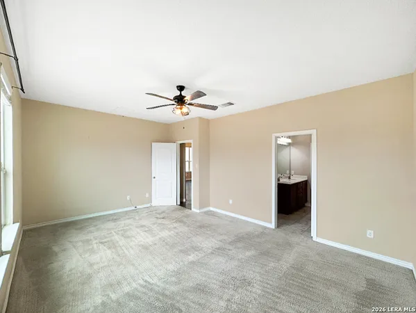 a view of an empty room with a ceiling fan