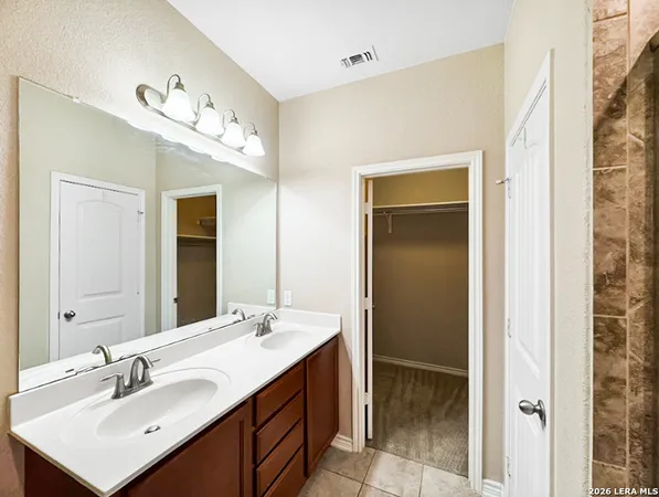 a bathroom with a sink vanity and mirror
