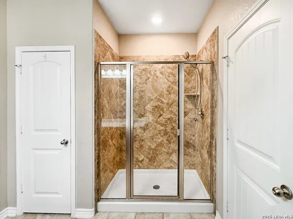 a bathroom with a glass shower door