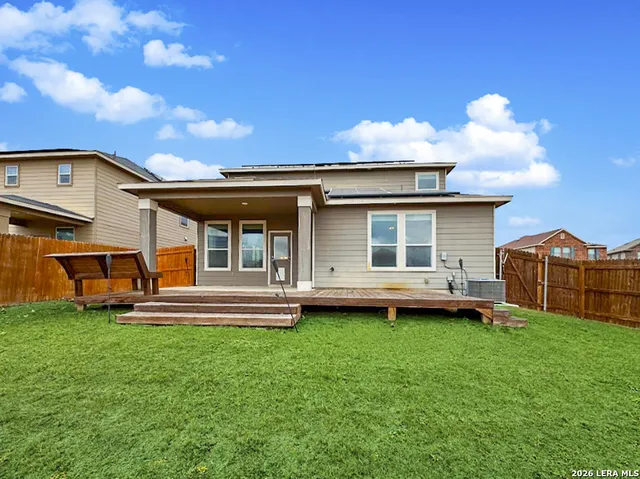 a view of a house with a yard and sitting area