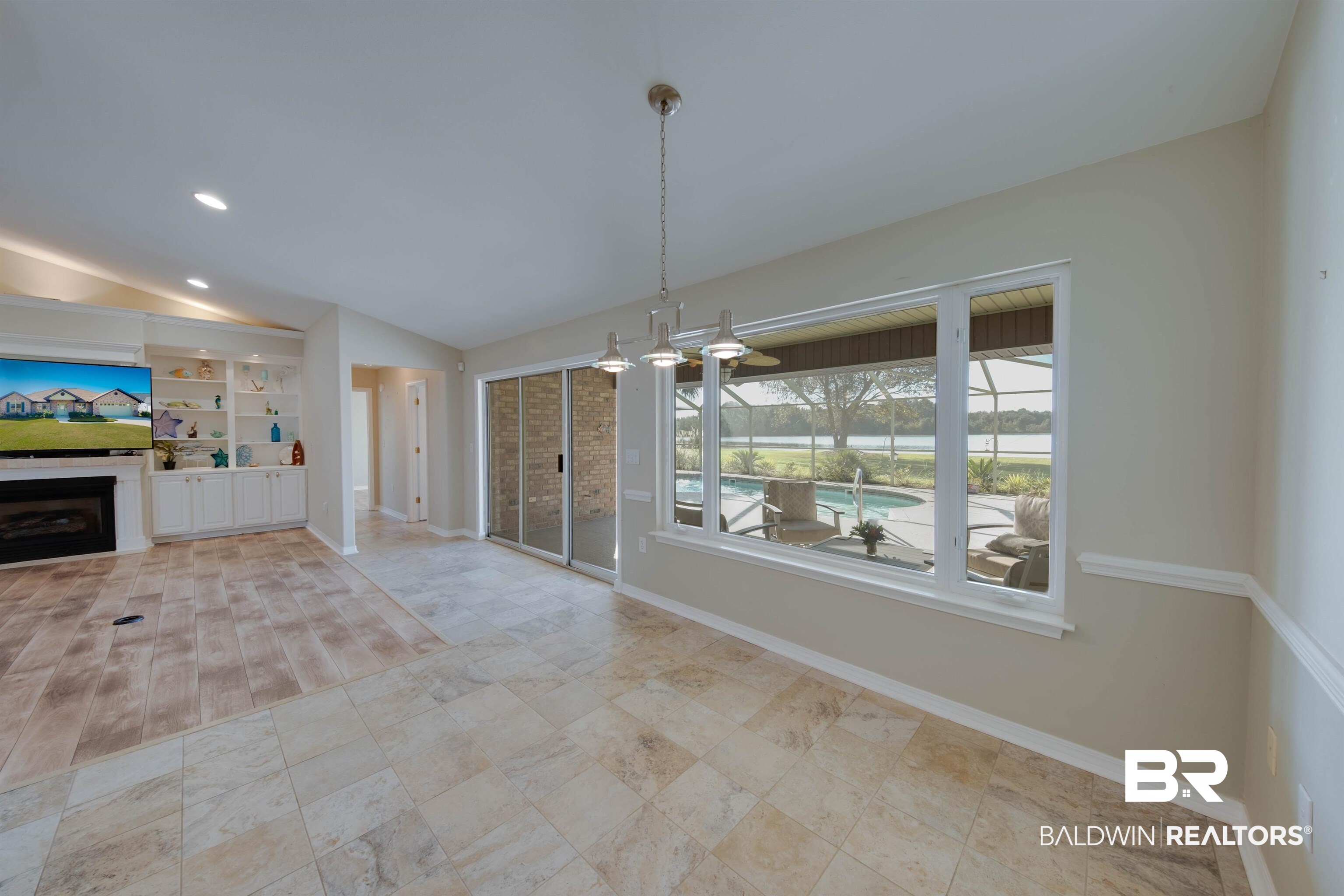 9462 Lakeview Drive Foley, AL 36535 - Photo 18 of 50 Unfurnished living room with light hardwood / wood-style flooring, built in features, and vaulted ceiling