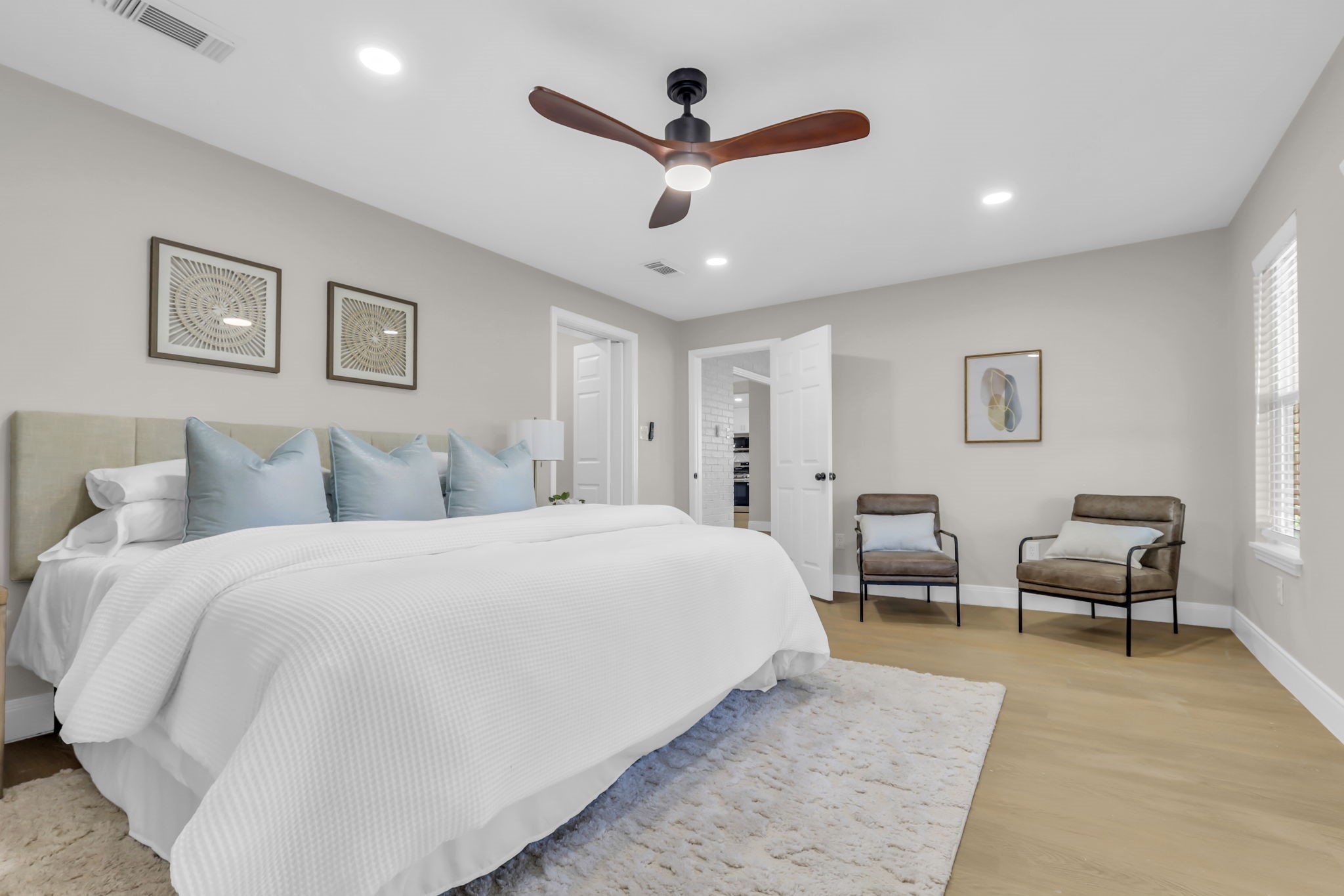 12106 Giusti Lane Santa Fe, TX 77510 - Photo 20 of 33 a spacious bedroom with a bed a couch and a ceiling fan
