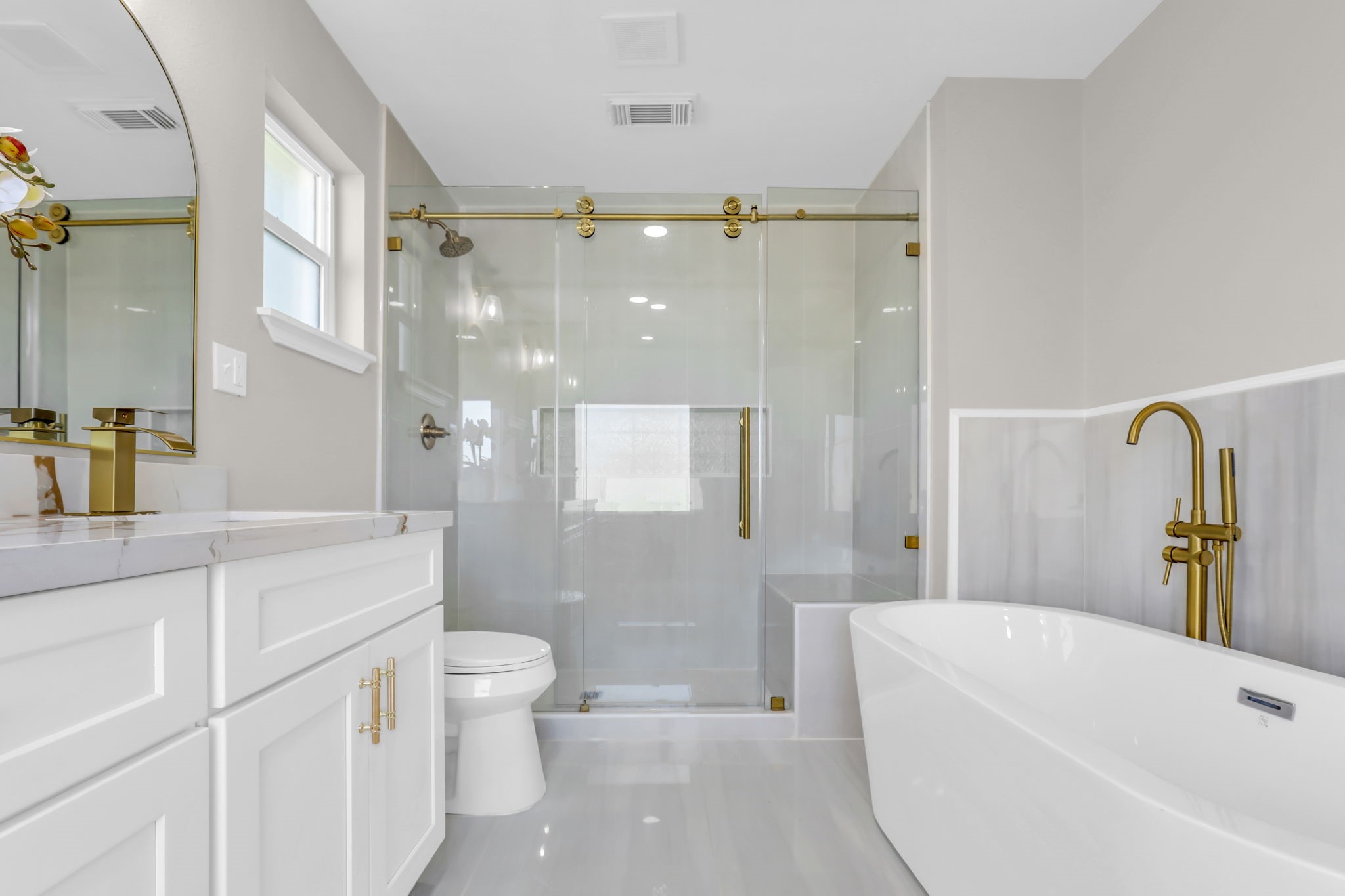 12106 Giusti Lane Santa Fe, TX 77510 - Photo 23 of 33 a bathroom with a bathtub shower sink vanity and toilet
