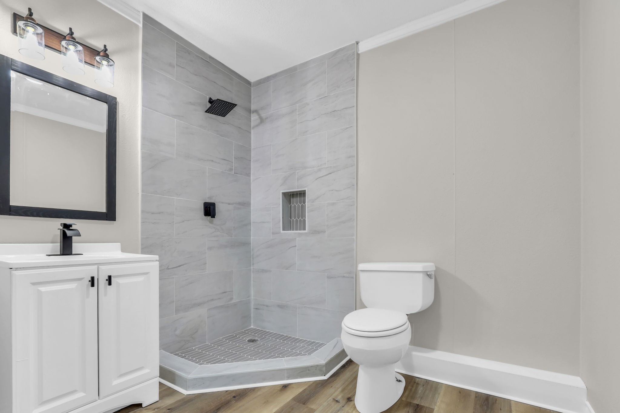 12106 Giusti Lane Santa Fe, TX 77510 - Photo 31 of 33 a bathroom with a toilet a sink and mirror