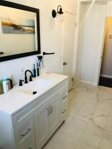 a bathroom with a sink and a mirror