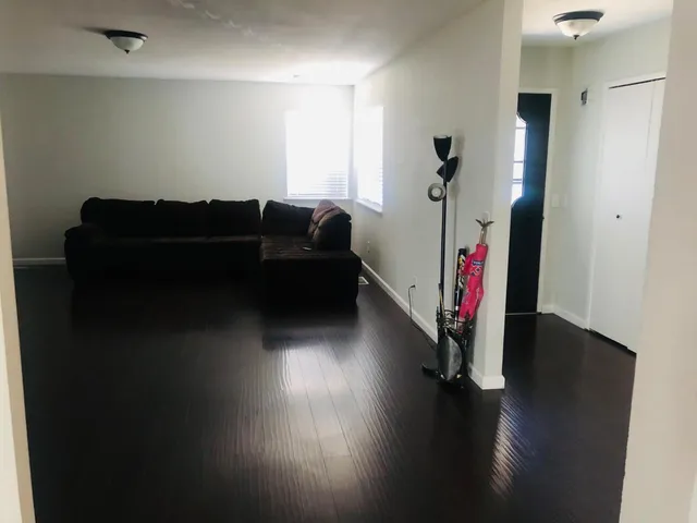 a living room with hard wood floors and a couch