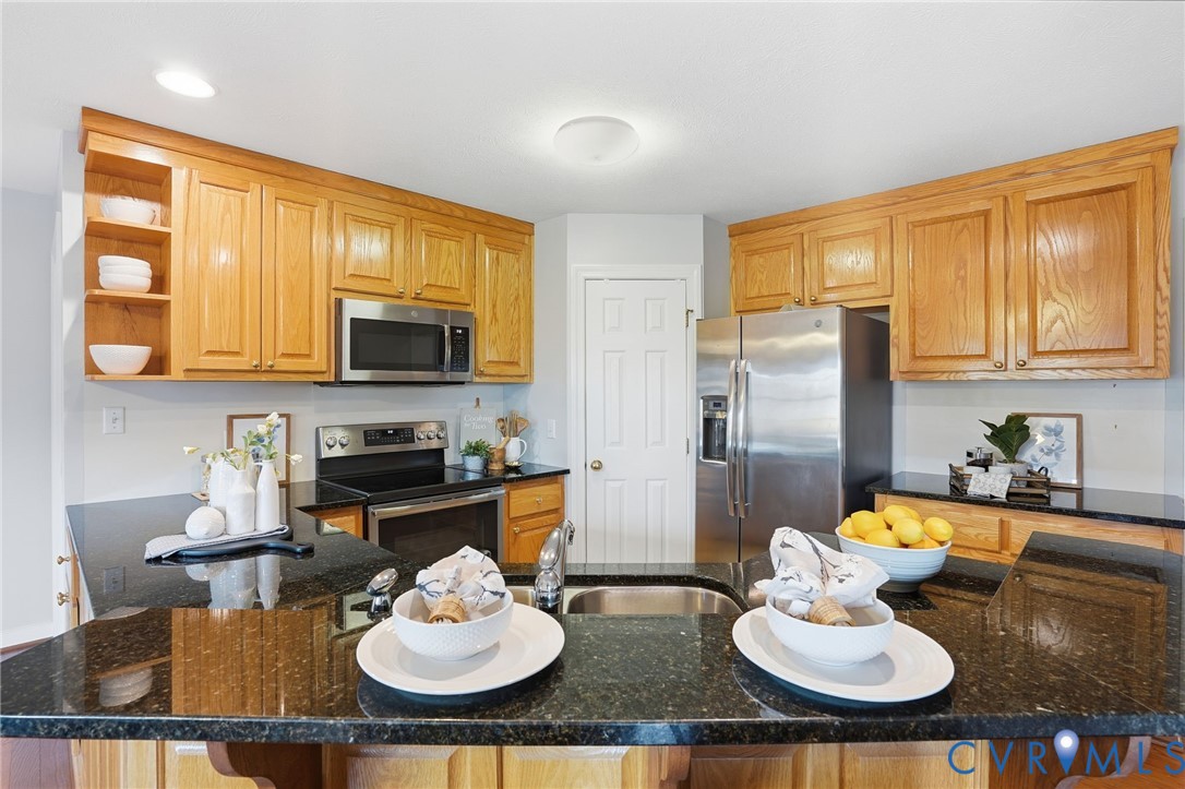 8420 Lee Davis Road Mechanicsville, VA 23116 - Photo 11 of 42 a kitchen with a table chairs stove and kitchen island