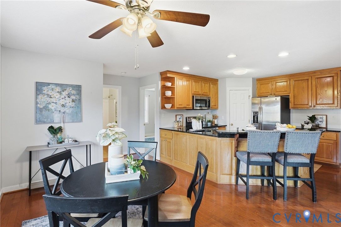 8420 Lee Davis Road Mechanicsville, VA 23116 - Photo 12 of 42 a view of a dining room with furniture and wooden floor