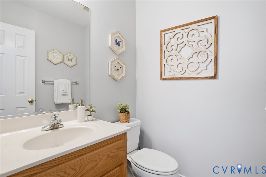 8420 Lee Davis Road Mechanicsville, VA 23116 - Photo 17 of 42 a bathroom with a sink mirror vanity and toilet