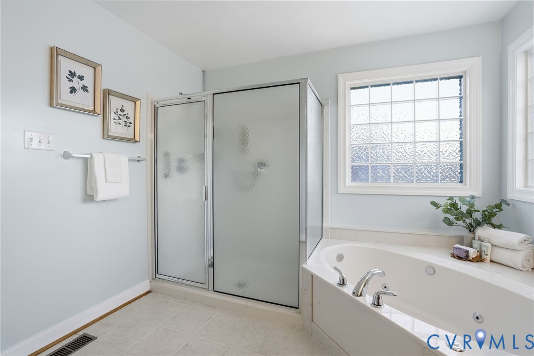 8420 Lee Davis Road Mechanicsville, VA 23116 - Photo 23 of 42 a bathroom with a bathtub and a shower